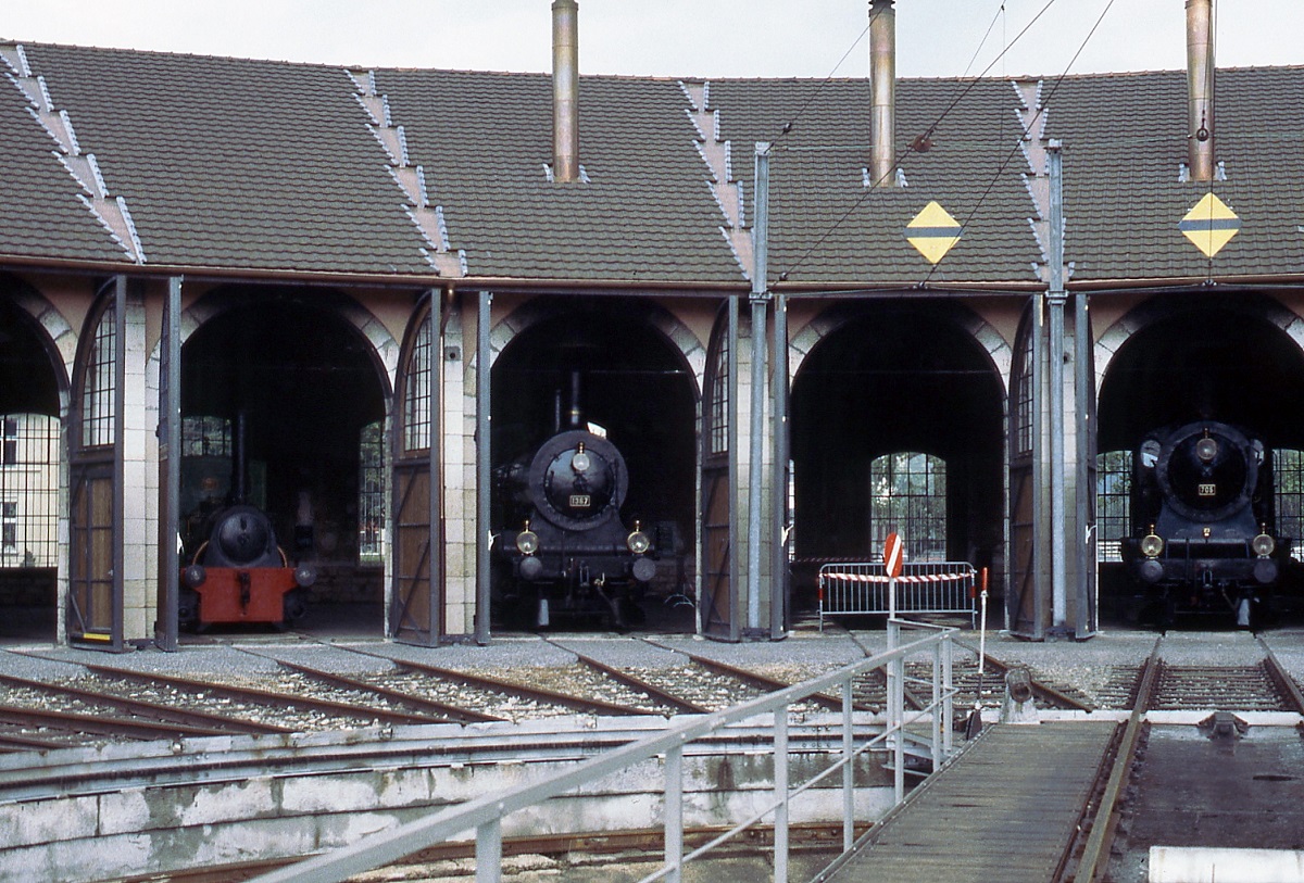 Blick von der Drehscheibe auf den Lokschuppen des Depots Delemont, in dem u. a. B 3/4 1367 und A 3/5 705 auf ihre n�chsten Eins�tze anl�sslich der Jubil�umsfeierlichkeiten  150 Jahre Eisenbahnen in der Schweiz  warten (Sommer 1997)