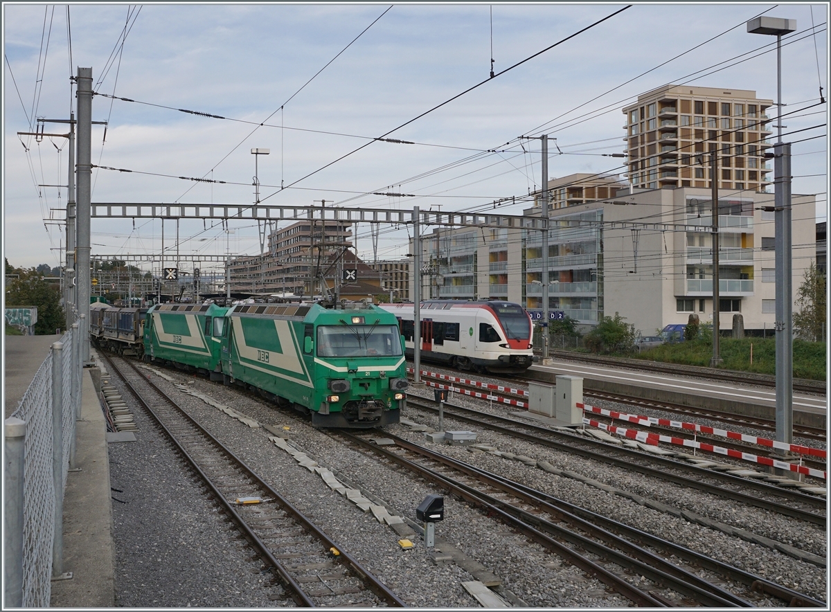 Die beiden BAM MBC Ge 4/4 21 und 22 rangieren in Morges ihren Kieszug, während ein SBB RABe 523 Morges in Richtung Allaman verlässt. 
Allem Anschein nach soll der Kiestransport ausgebaut werden; erfolgt die Planung positiv, wird die BAM (mit der MOB) neuen Loks bestellen und die Ge 4/4 21 und 22 ev. der RhB weitergeben.

18. Okt. 2021