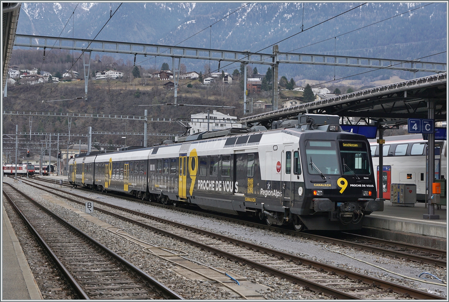 Eigentlich eine  Pflicht-Aufnahme : der Region Alps Domino RBDe 560 414 mit Kanal 9 Werbung vermag nicht sonderlich zu begeistern. Hier wird der Triebwagen nach der Ankunft in Brig in einen anderen Bahnhofsteil rangiert.

2. Feb. 2024
