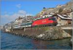 Eine SBB Re 460 ist mit einem IR von Brig nach Genève Aéroport bei St-Saphorin unterwegs.